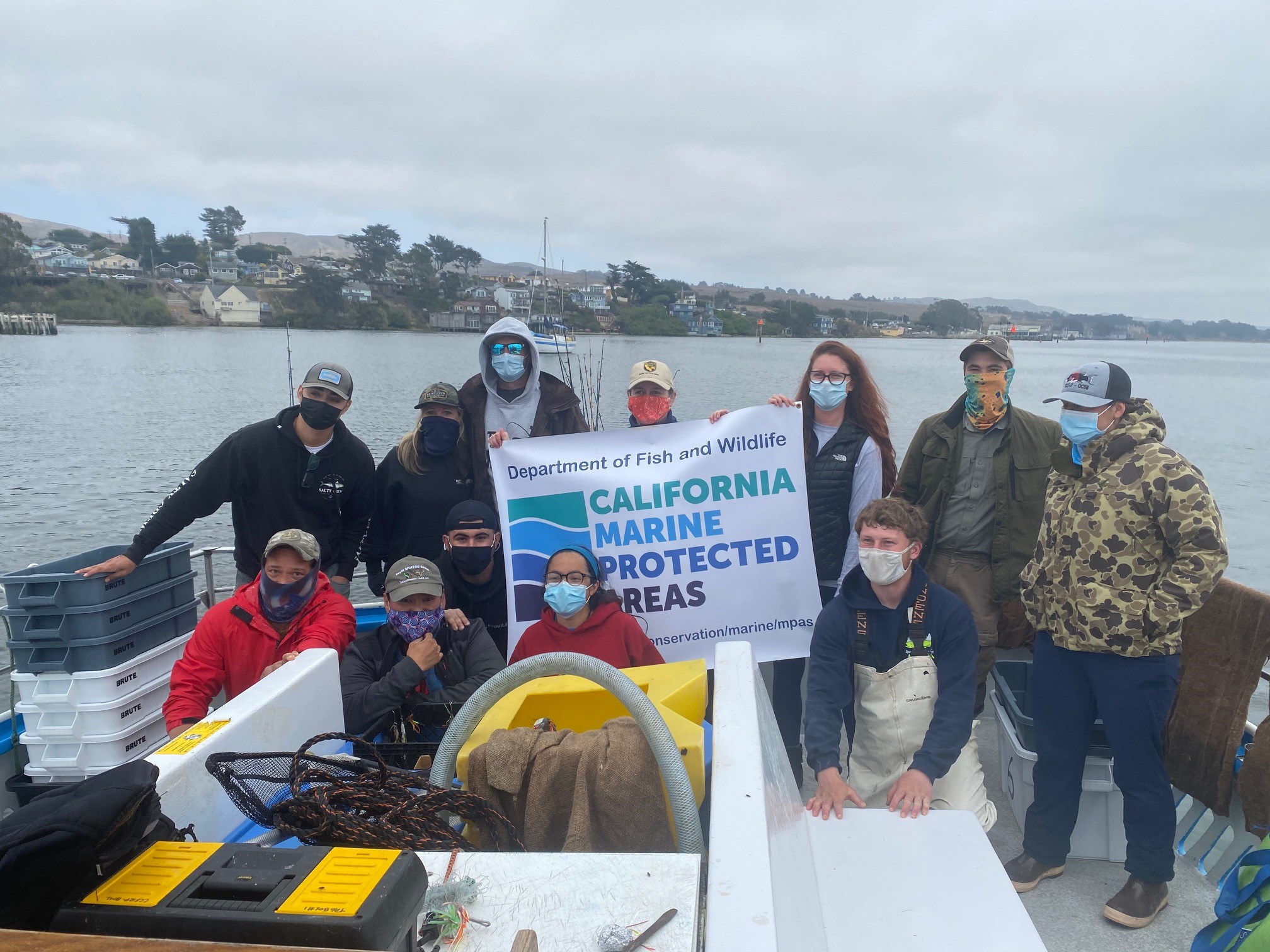 Researchers holding MPA banner on boat